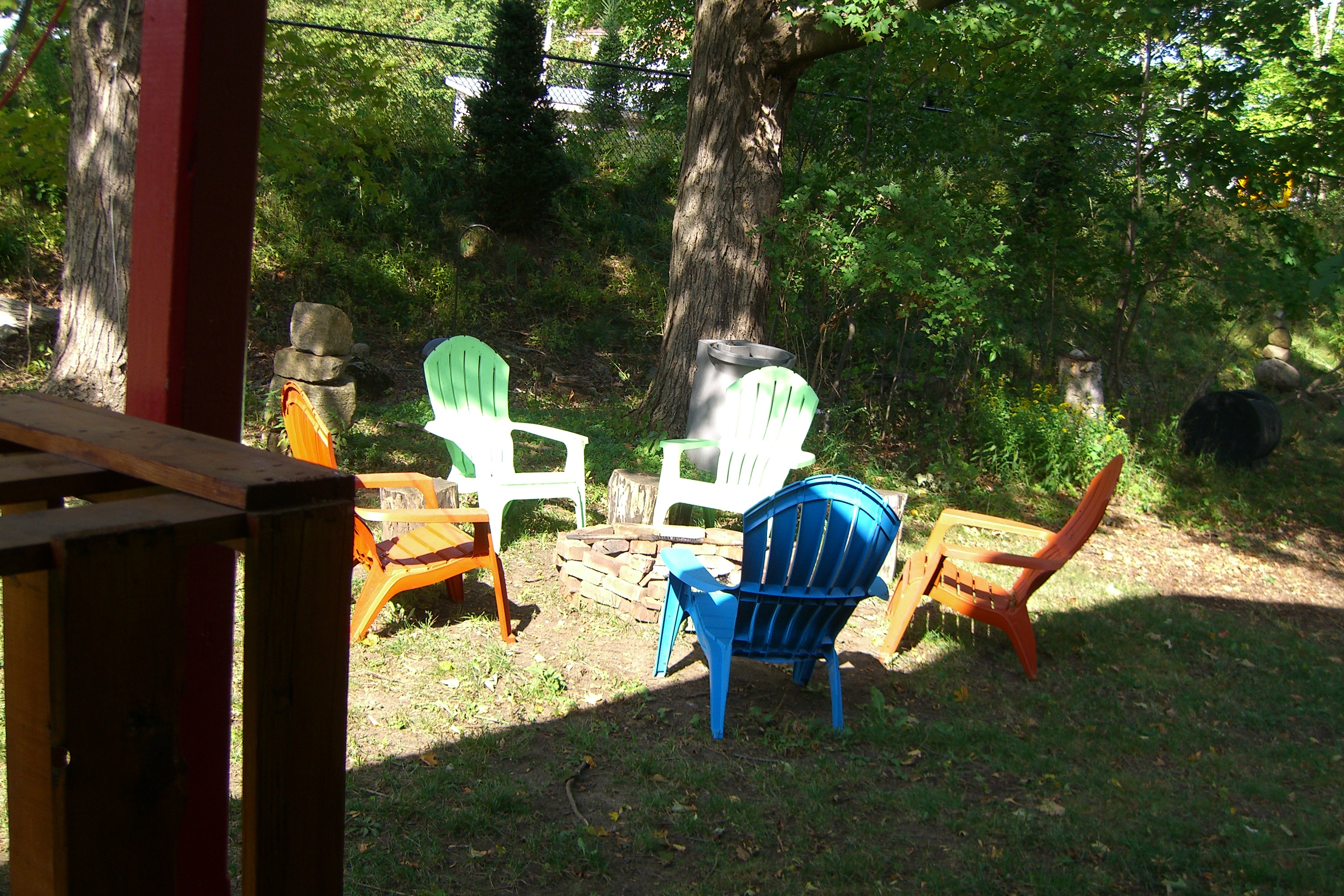 Colorful chairs around a fire pit